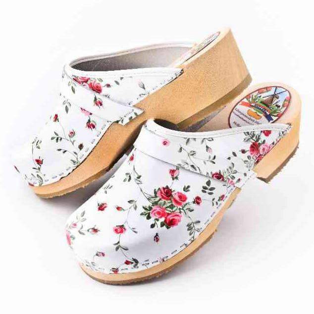 white clogs with flowers
